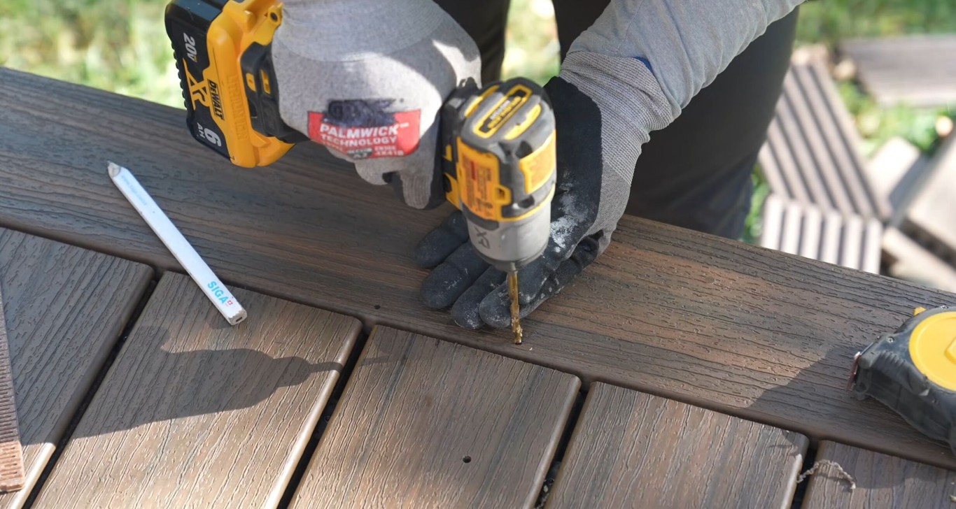 Professional deck builder installing composite deck boards